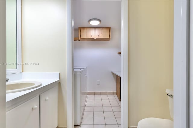 bathroom with tile patterned flooring, vanity, and toilet