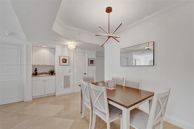 tiled dining area with crown molding and sink