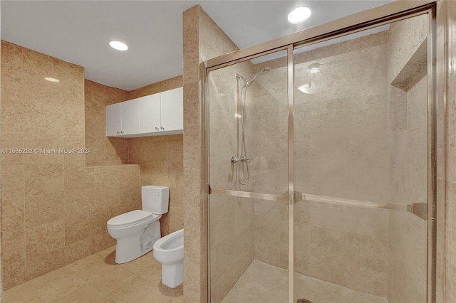 bathroom featuring tile walls, a bidet, walk in shower, tile patterned floors, and toilet