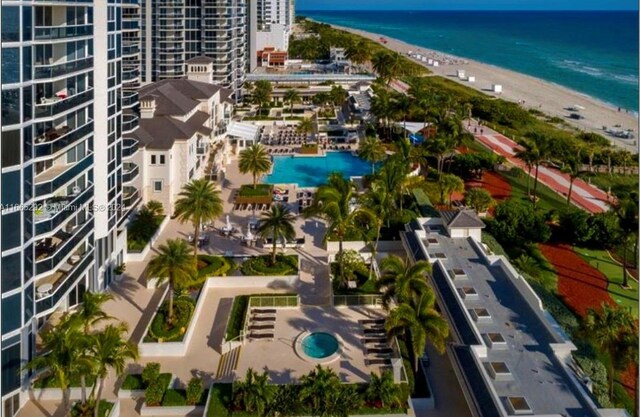 bird's eye view featuring a view of the beach and a water view