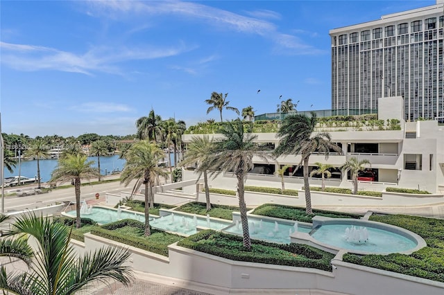 exterior space featuring a water view and a pool