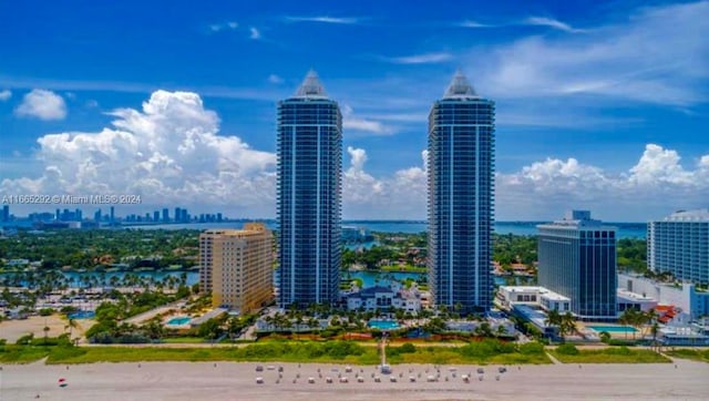 view of city featuring a water view and a beach view