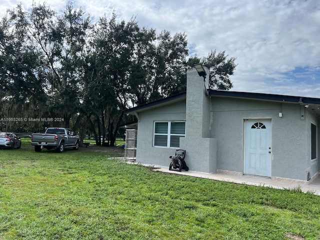 14721 Arbuckle Creek Rd, Sebring, FL 33870 - back of house featuring a lawn