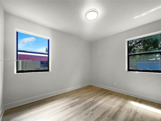 empty room with a healthy amount of sunlight and light wood-type flooring