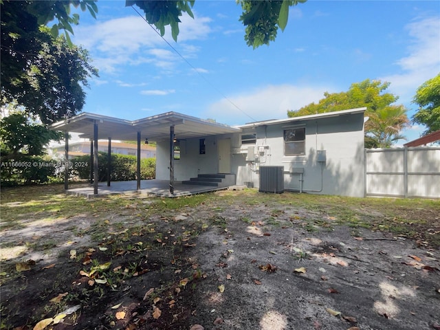 back of property with cooling unit and a patio