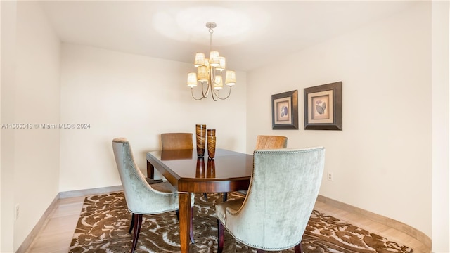 dining room featuring hardwood / wood-style floors and a notable chandelier