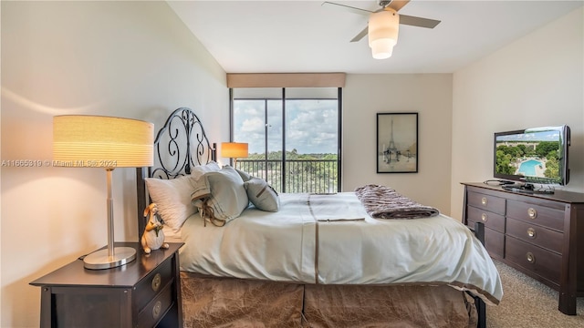 carpeted bedroom featuring multiple windows, access to exterior, and ceiling fan