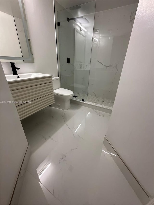 bathroom featuring walk in shower, vanity, and toilet