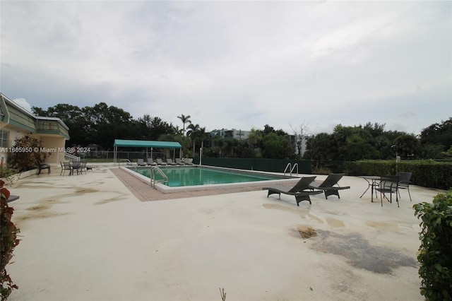 view of swimming pool featuring a patio area