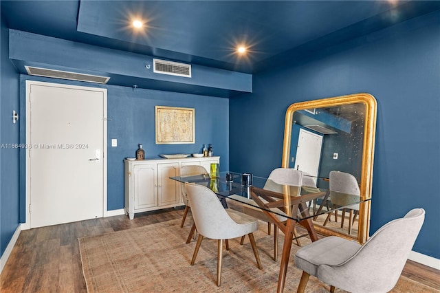 dining area with baseboards, wood finished floors, visible vents, and recessed lighting