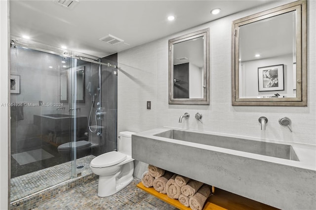 bathroom featuring tile patterned floors, an enclosed shower, vanity, and toilet