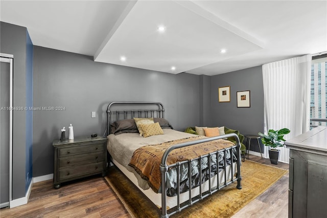 bedroom featuring recessed lighting, wood finished floors, and baseboards