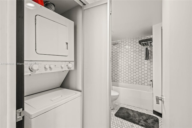 bathroom with toilet, stacked washer and clothes dryer, and shower / bath combo with shower curtain