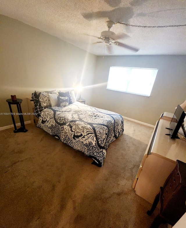 bedroom with carpet flooring, a textured ceiling, and ceiling fan