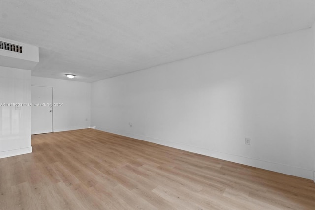 unfurnished room with light hardwood / wood-style floors