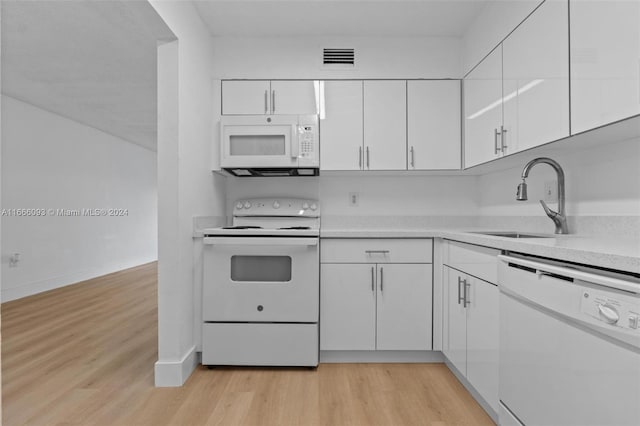 kitchen with light hardwood / wood-style flooring, white cabinets, white appliances, and sink