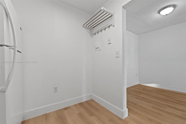 interior space with wood-type flooring and a textured ceiling