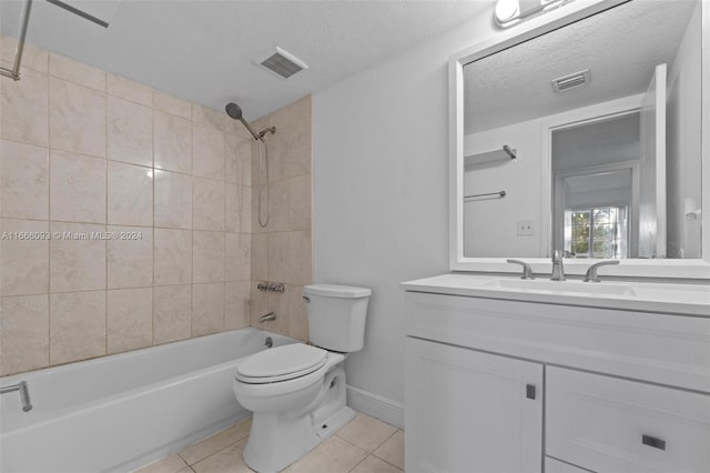 full bathroom featuring tile patterned flooring, tiled shower / bath combo, vanity, and toilet