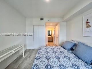 bedroom featuring light wood-type flooring and a closet