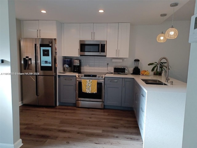 kitchen with gray cabinets, appliances with stainless steel finishes, dark hardwood / wood-style floors, and sink