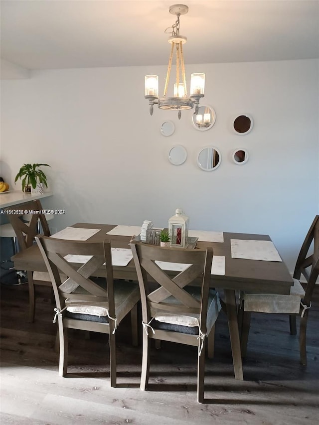 dining space with a notable chandelier and hardwood / wood-style flooring