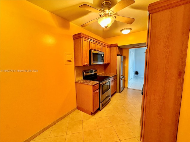 kitchen featuring stainless steel appliances, ceiling fan, and light tile patterned floors