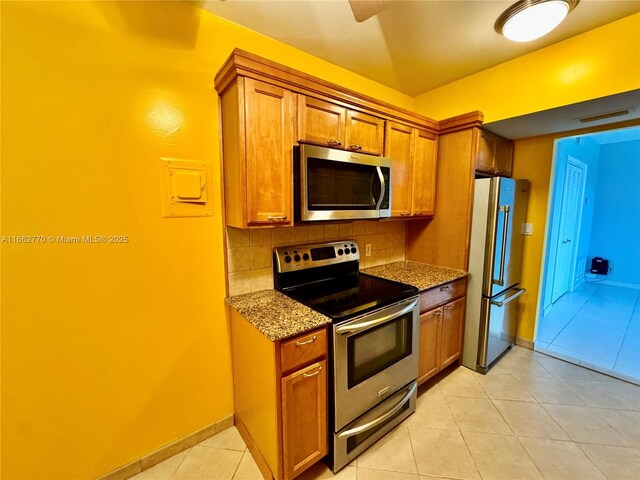 kitchen with tasteful backsplash, stainless steel dishwasher, sink, and light stone countertops