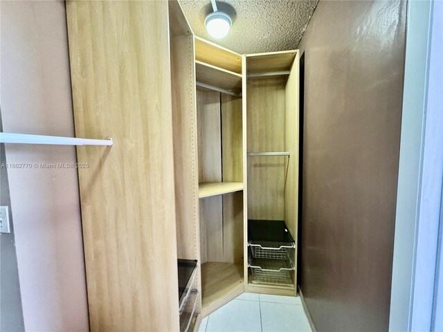 walk in closet featuring light tile patterned floors