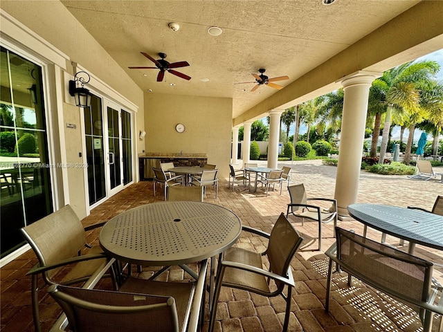 view of patio featuring french doors and ceiling fan