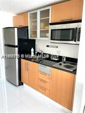 kitchen with appliances with stainless steel finishes and light tile patterned floors