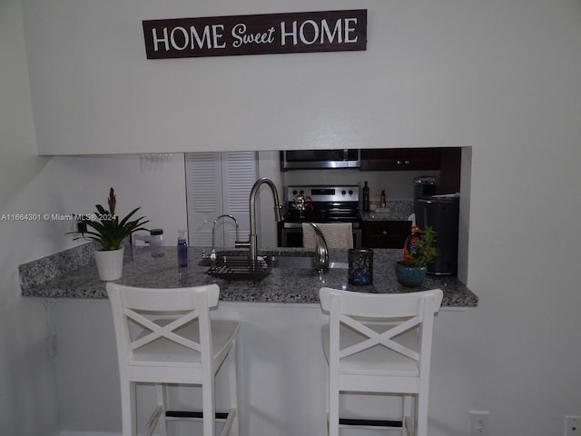 kitchen featuring appliances with stainless steel finishes and a breakfast bar