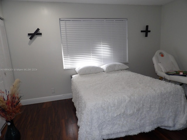 bedroom with dark hardwood / wood-style flooring