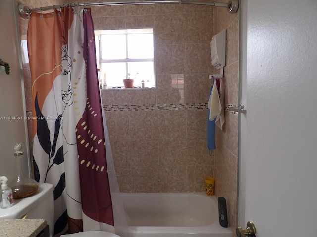 bathroom featuring shower / bath combo and toilet