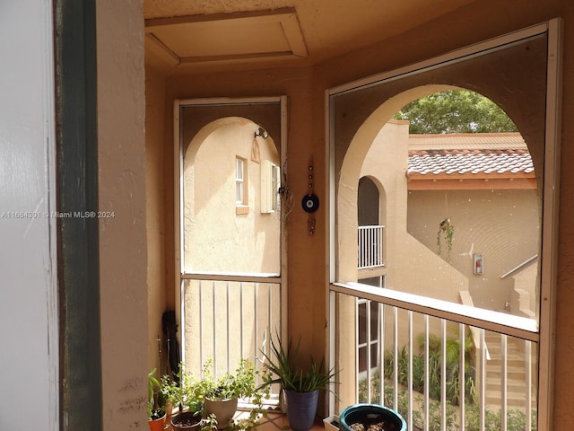 view of exterior entry featuring a balcony