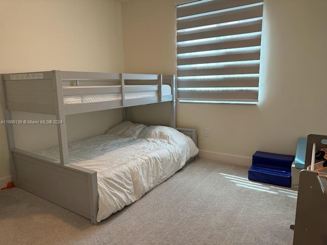 bedroom with light colored carpet