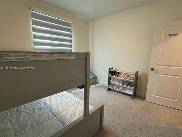 spare room featuring light carpet and a textured ceiling