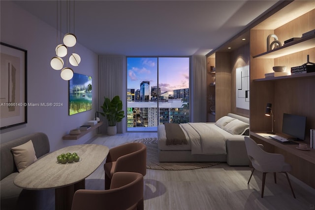 dining space with light wood-type flooring and floor to ceiling windows