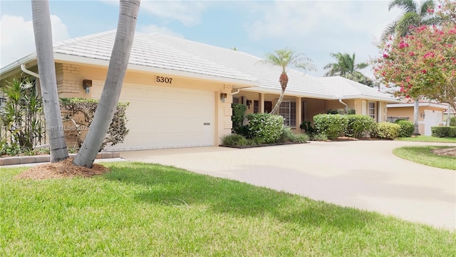 view of front of home featuring a front lawn and a garage