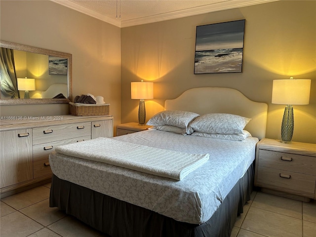 bedroom featuring ornamental molding and light tile patterned flooring