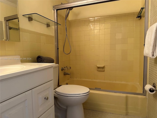 full bathroom featuring tile walls, backsplash, vanity, bath / shower combo with glass door, and toilet