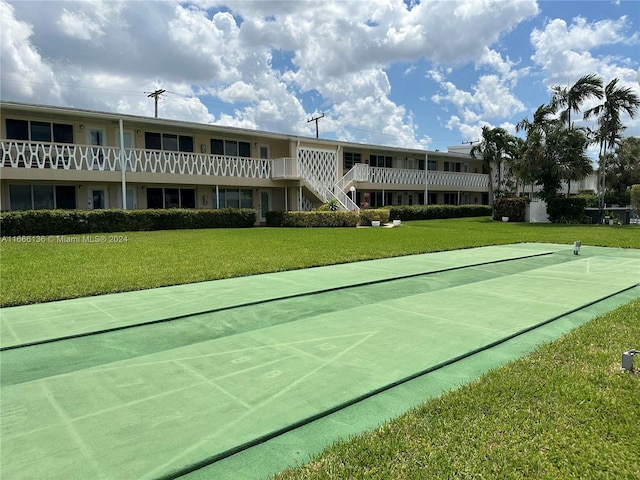 view of property's community with a yard