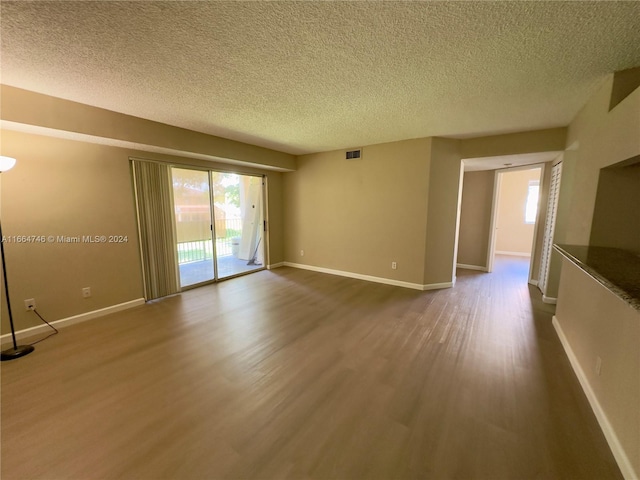 interior space featuring hardwood / wood-style flooring and a textured ceiling