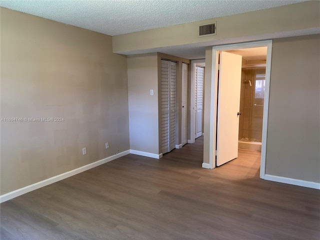 unfurnished bedroom featuring a textured ceiling and hardwood / wood-style flooring