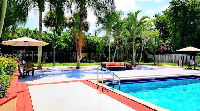 view of pool featuring an outdoor living space and a patio area