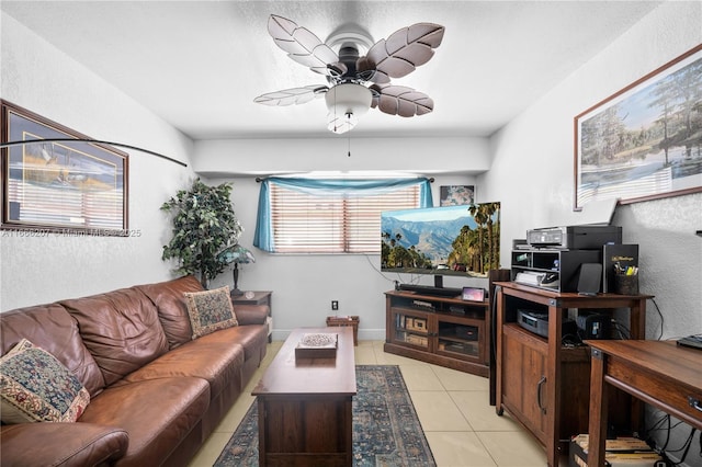 living room with a ceiling fan and light tile patterned flooring