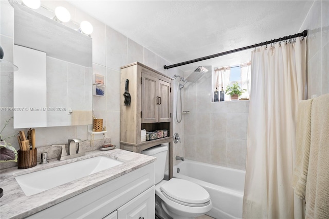 full bath with shower / tub combo with curtain, vanity, tile walls, and toilet