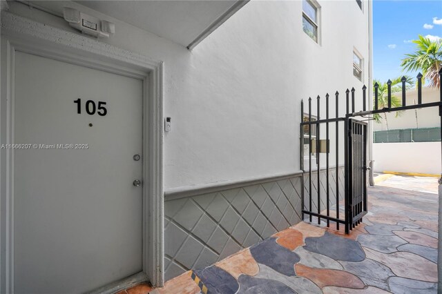 property entrance with stucco siding