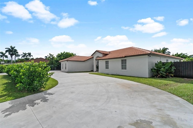 mediterranean / spanish home featuring a front yard