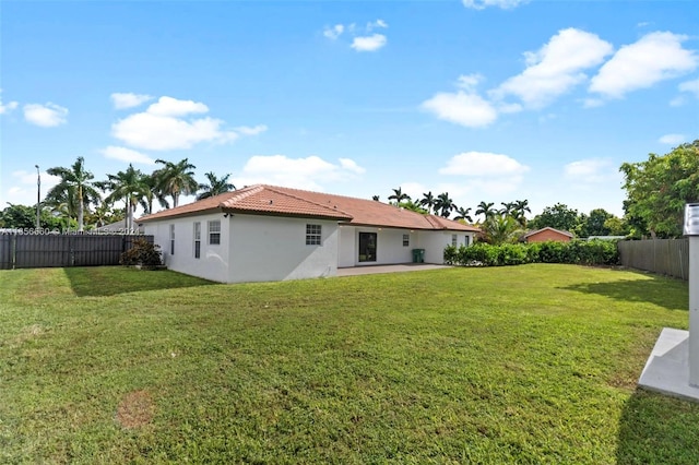 back of property featuring a yard and a patio area