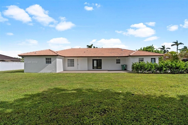 back of house featuring a patio and a yard